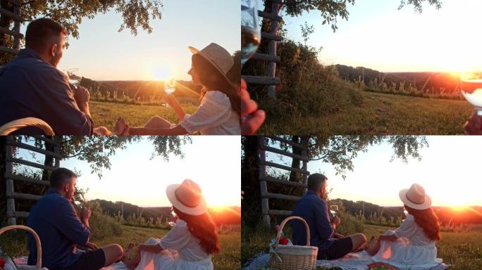 慢动作年轻夫妇在日落时在葡萄园附近喝酒