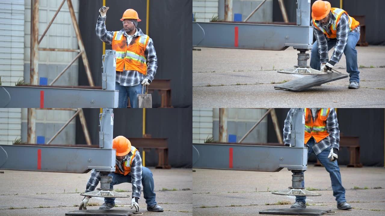 建筑工人帮助设置起重机支腿