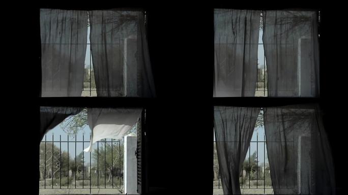 在阿根廷一所简陋的乡村房屋中，窗帘从敞开的窗户随风飘动。