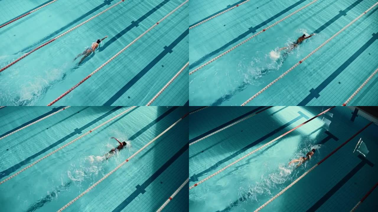 美丽的女游泳运动员在游泳池潜水。职业运动员优雅地跳跃，全速游泳。女人决心赢得冠军并创造世界纪录。电影
