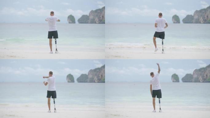 早上在海滩上做伸展运动的假肢残疾男子的后视图。残疾收藏: 日常生活理念