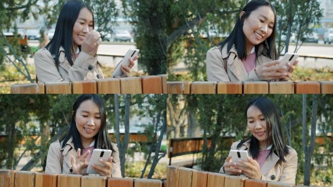 开朗的亚洲女商人的肖像看着外面带着灿烂的笑容看着智能手机屏幕