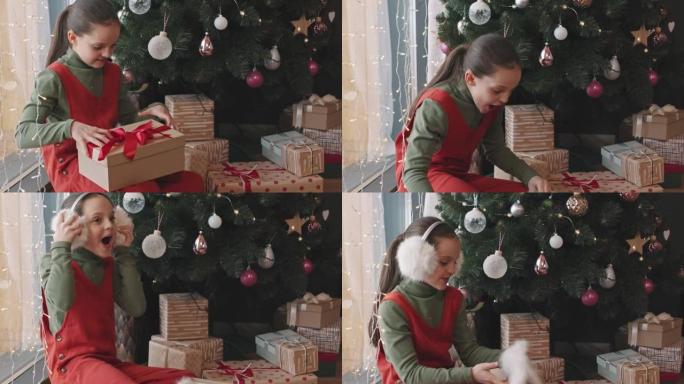 女孩打开圣诞礼物盒的包装