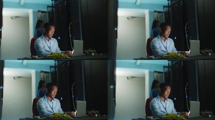 在商务服务器室工作的非裔美国男性计算机技术员笔记本电脑