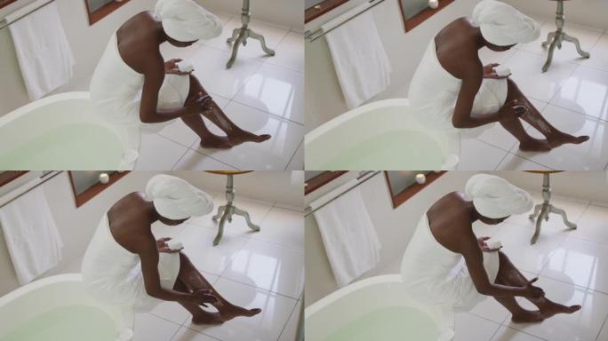 非裔美国迷人女性在浴室涂抹润唇膏的高角度视图