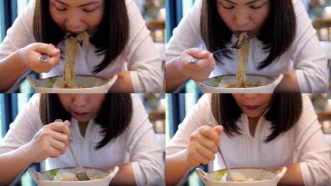 吃面条的亚洲女人吃面条的亚洲女人