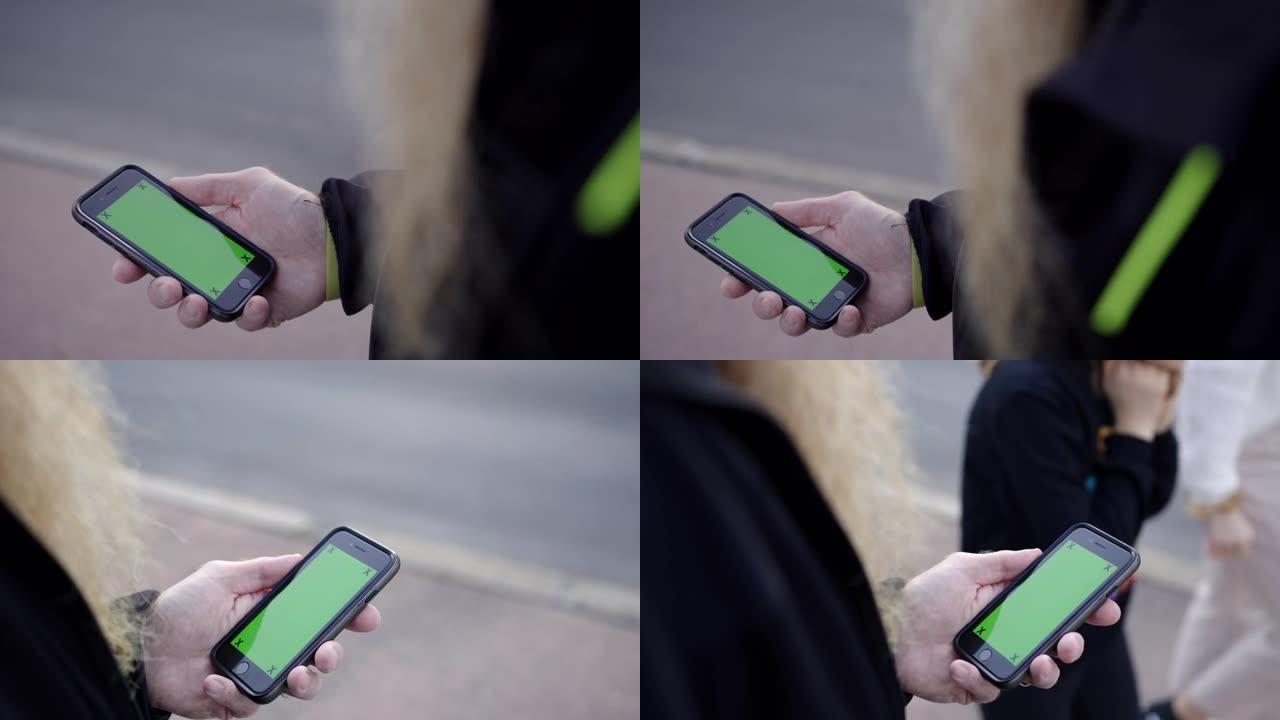使用带有绿屏的智能手机，无法识别的胡须男子女士