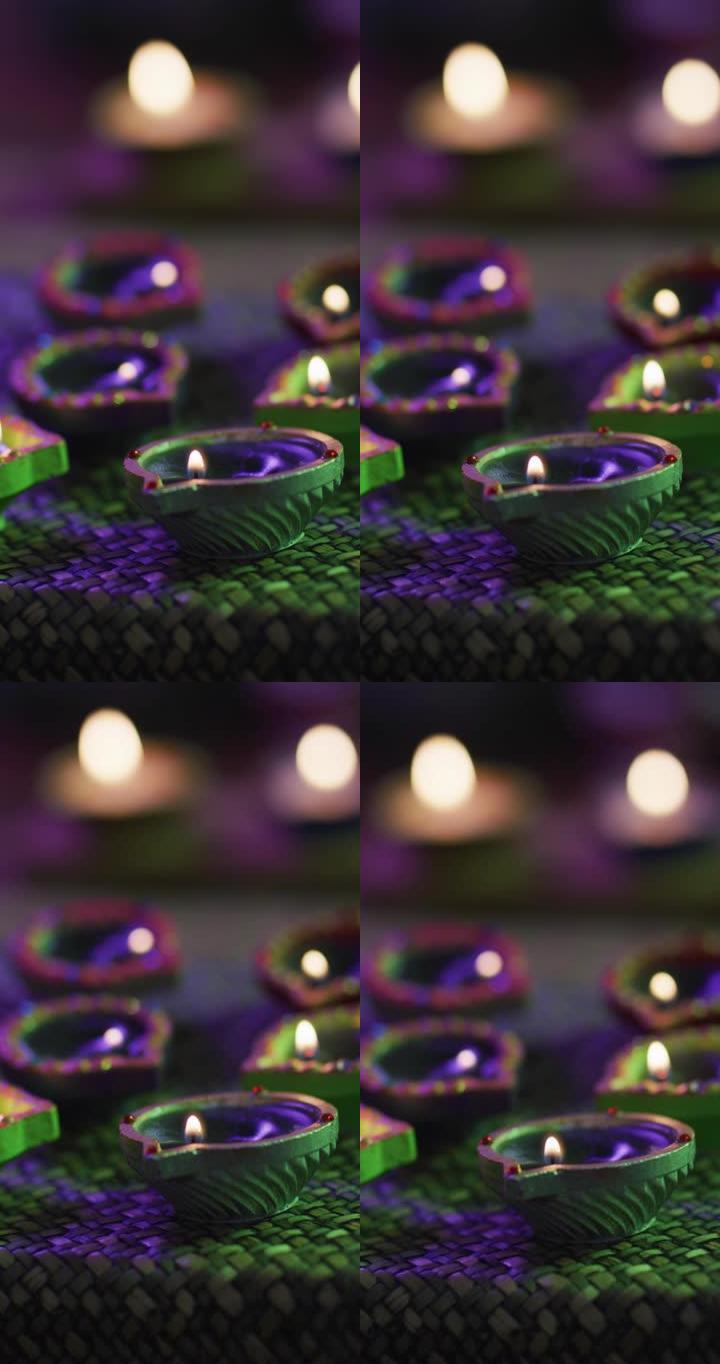 多个绿色Diya蜡烛的垂直特写镜头