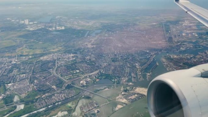 空中: 在阿姆斯特丹上空飞行时，飞机机翼的风景窗视图。