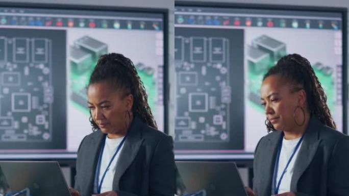 在实验室编程机械臂时，黑人开发人员在笔记本电脑上打字。女人用集中的脸编码。计算机语言和编程概念。垂直