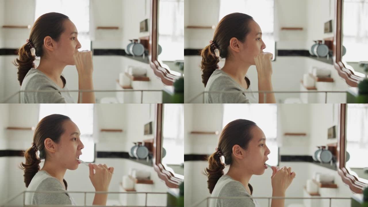 亚洲妇女刷牙女人刷牙侧面口腔卫生
