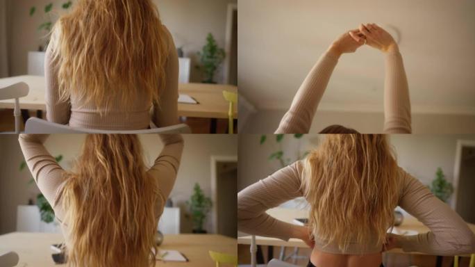 女人伸出双臂，从工作中休息一下