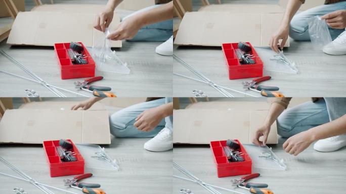 男人在家忙着做家务时，用金属螺丝拍摄男性手的低角度镜头