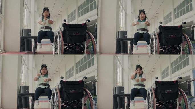 坐在轮椅上的残疾年轻女子准备在健身房训练。