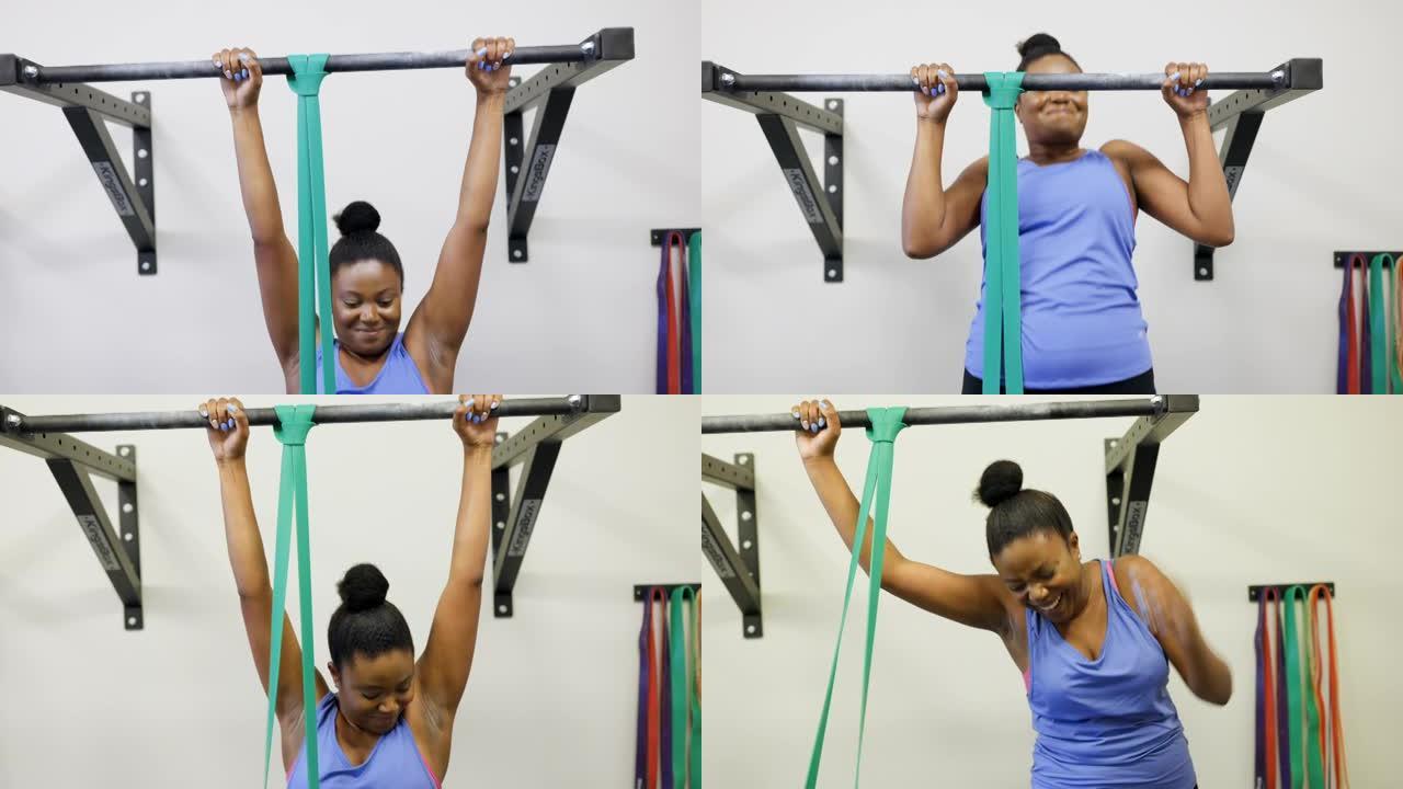 强壮的非洲妇女在健身房的酒吧里做俯卧撑