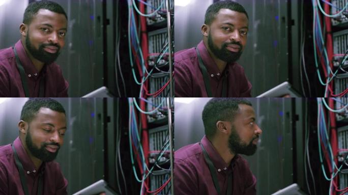 一个年轻人在服务器机房工作时使用数字平板电脑的4k视频片段