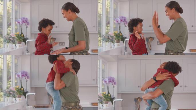 穿着军装回家休假的军人母亲在家里的厨房里和儿子击掌，然后抱起他，给他一个拥抱——慢镜头