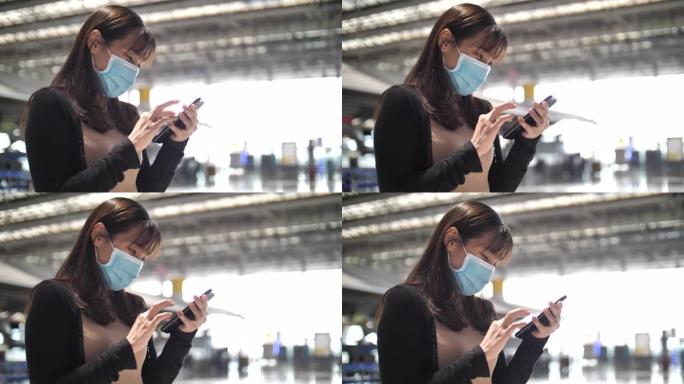亚洲妇女在机场使用智能手机，商务旅行