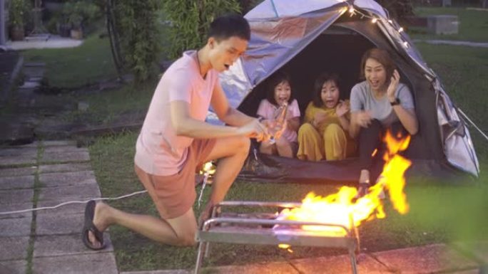 亚洲华人家庭在他们的房屋后院建立消防露营周末活动