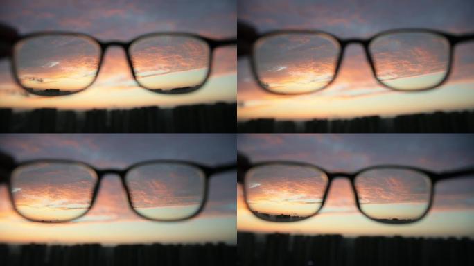 透过眼镜看城市日落