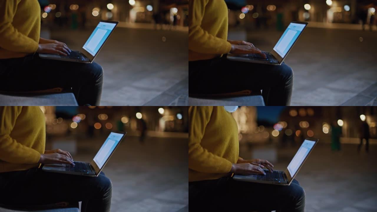 DS年轻黑人妇女晚上在城市使用笔记本电脑