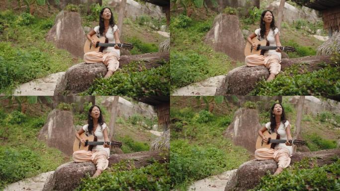 女人在热带自然中弹吉他
