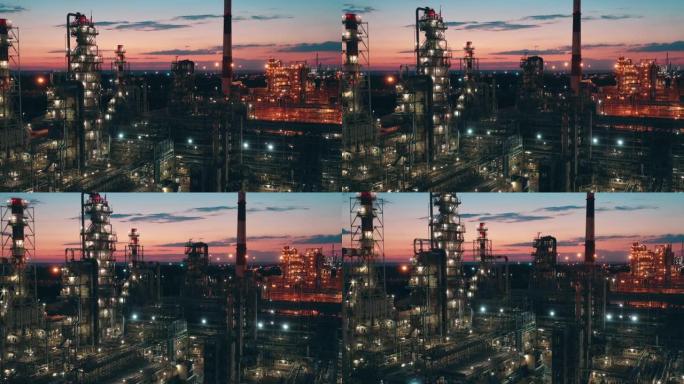 日落时拍摄的炼油厂的建筑