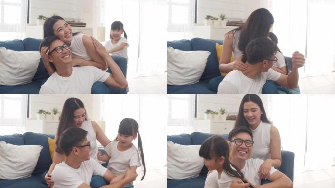 快乐快乐的亚洲家庭爸爸、妈妈和女儿在家里过生日时在地板上玩耍。