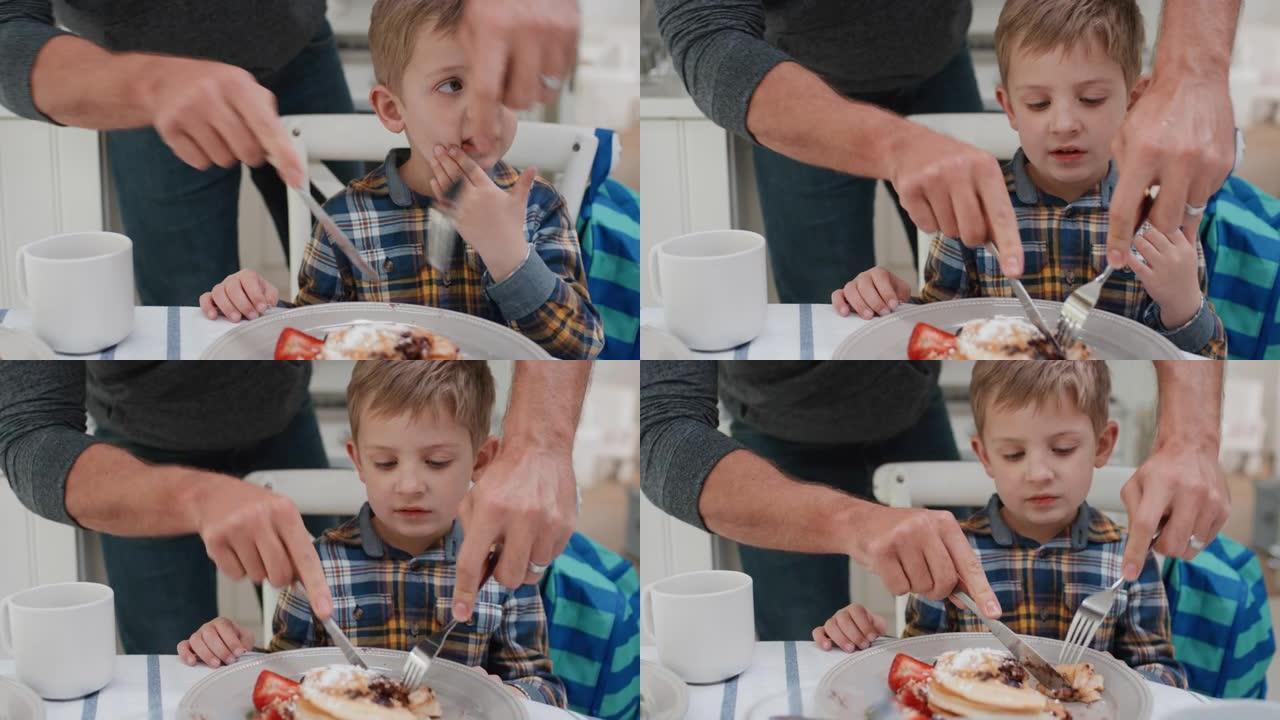 父亲为儿子准备早餐华夫饼可爱的小男孩在家厨房享受美味的自制饭菜4k