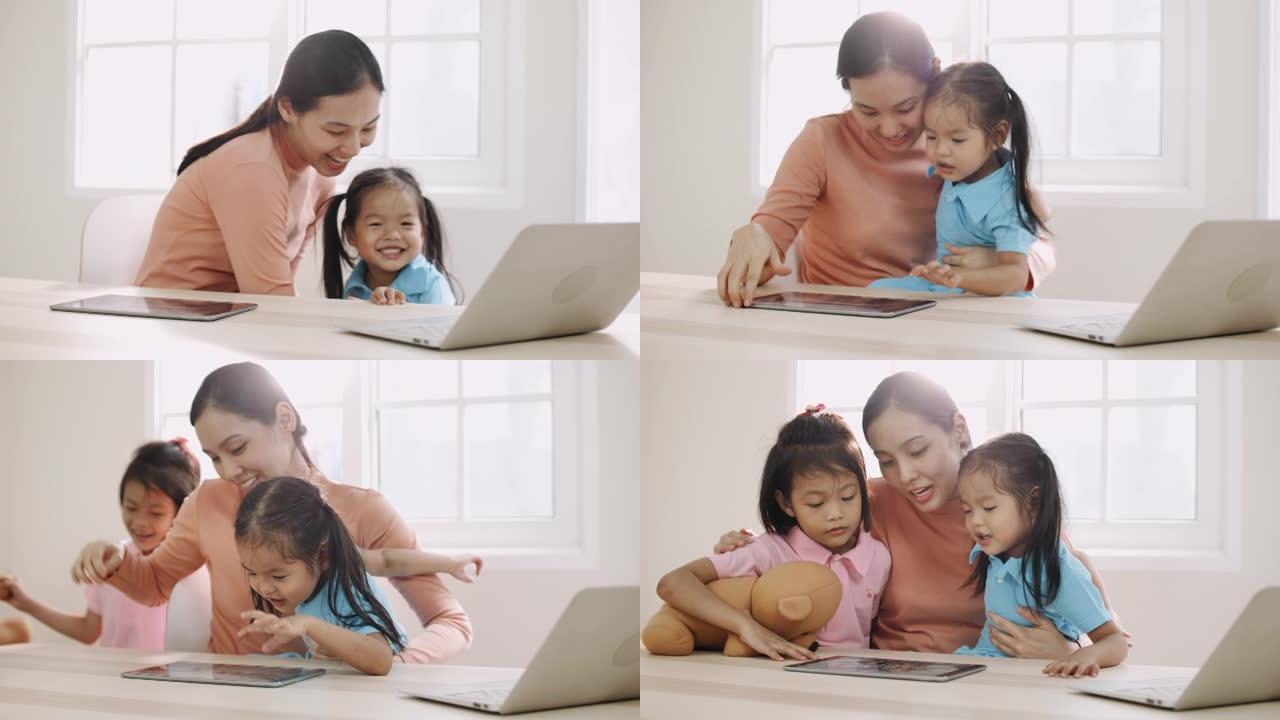 年轻的母亲与女儿一起使用计算机在家工作