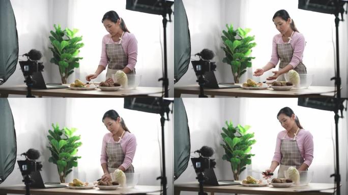 亚洲女性视频记录器制作关于互联网烹饪的社交媒体视频