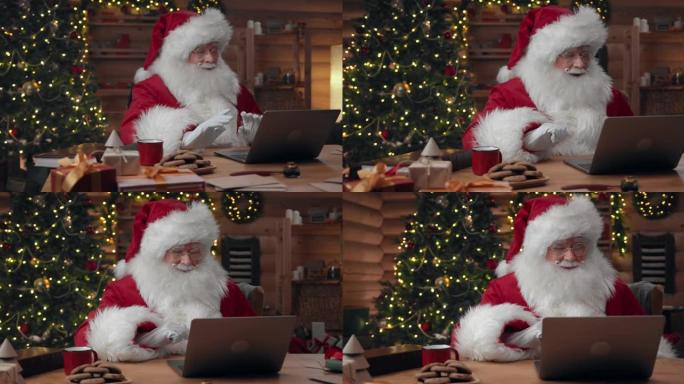 圣诞老人正在使用笔记本电脑在线聊天，情绪积极