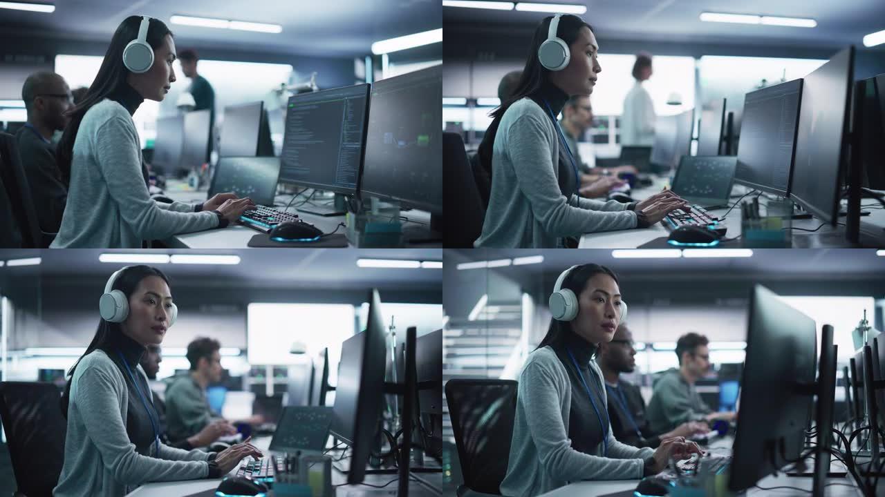 一位有思想的年轻工程师在技术办公环境中从事计算机工作的肖像。美丽的亚洲女人戴着耳机，为区块链项目编写