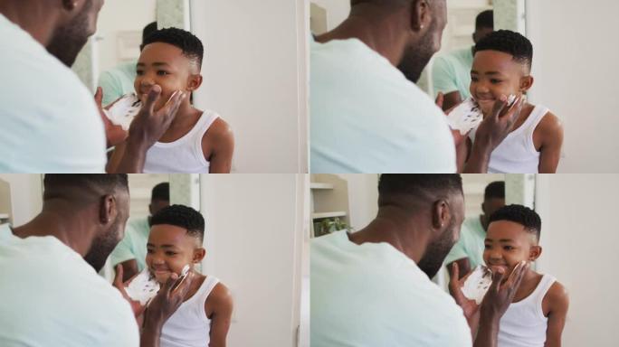 非裔美国父亲将剃须膏放在儿子的嘴上，一起大笑
