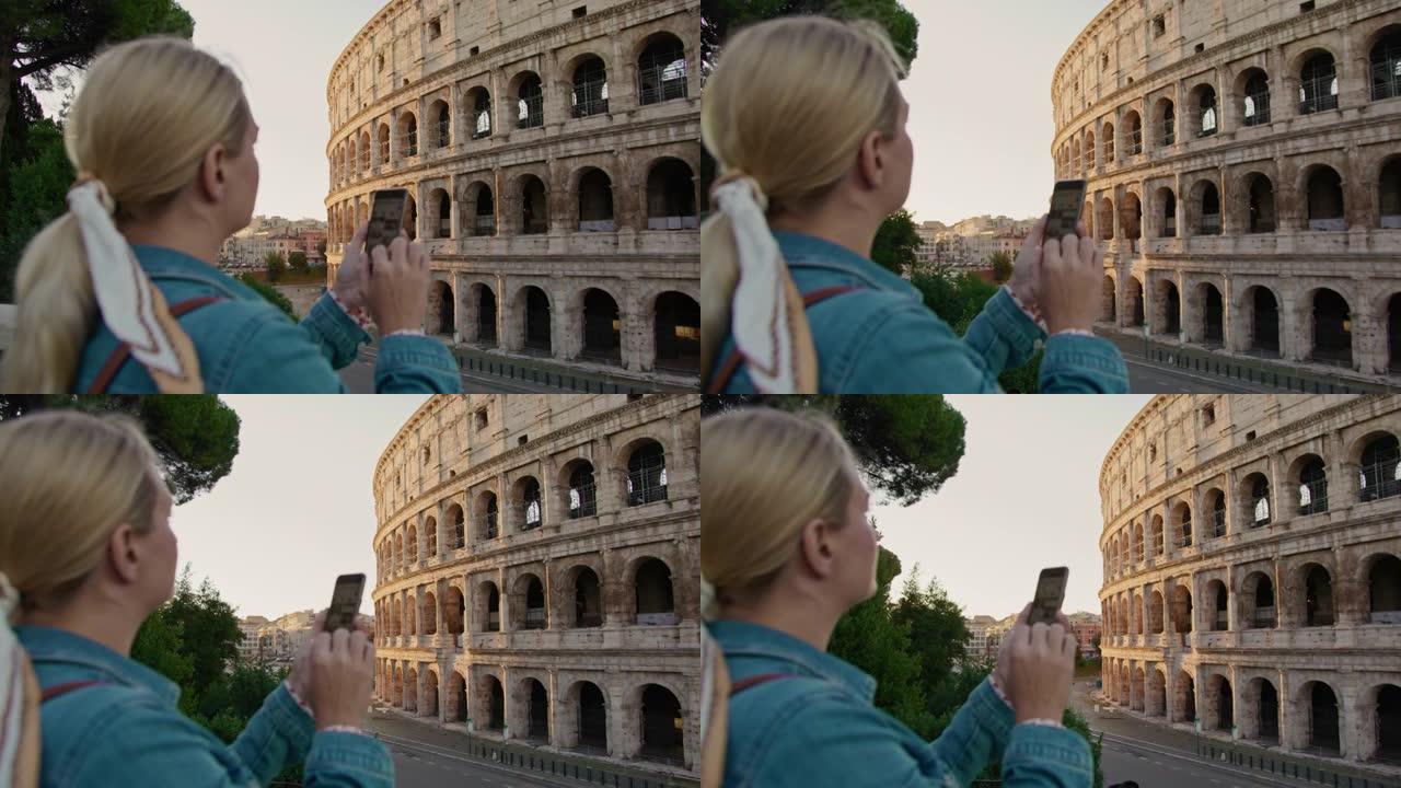 SLO MO女游客使用智能手机搜索有关罗马斗兽场的指南信息