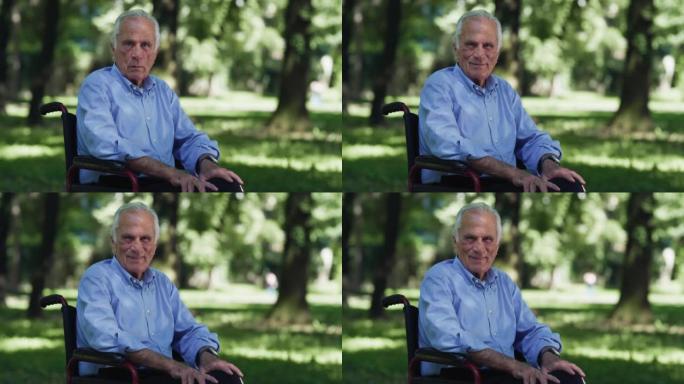 坐在轮椅上的老年残疾老人的电影镜头在绿色公园被大自然包围的镜头中微笑。生活概念，养老金领取者，祖父母