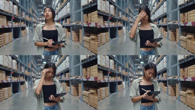 不快乐的年轻亚洲女商人在零售购物中心使用数字平板电脑检查库存水平时看起来和感到困惑。