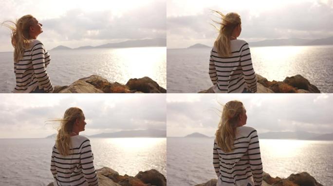 意大利厄尔巴岛沿岸一个金发女孩的慢动作视图。