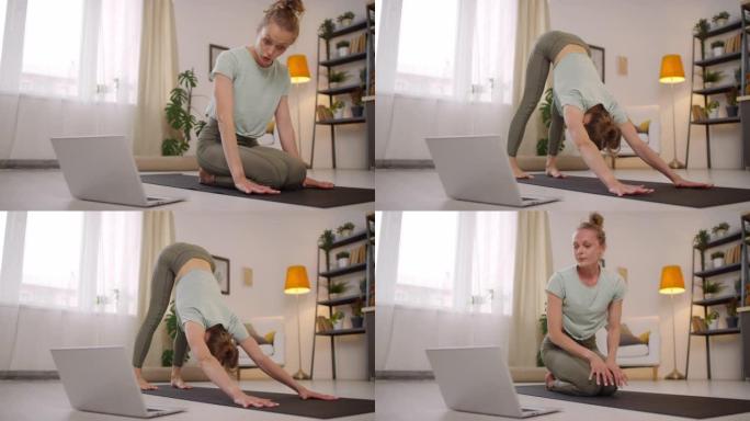 女瑜伽教练在网上上课时摆出姿势
