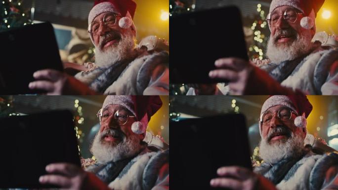 带平板电脑的快乐圣诞老人