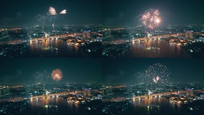 空中无人机视角多颜色的烟花表演在天空之城。新年前夜。摩天大楼和城市景观庆祝夜晚的灯光