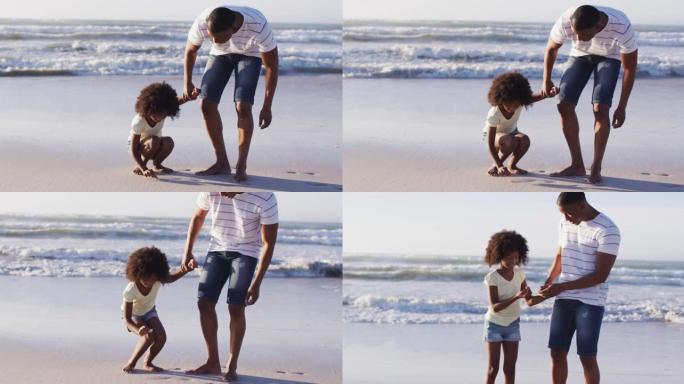 非洲裔美国父女在海滩上一起从沙子上捡起贝壳
