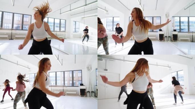 展示健身舞蹈的年轻女子在健身房上课