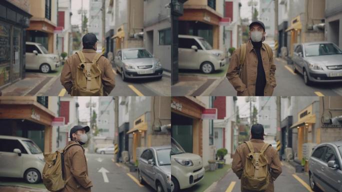 在韩国当地城市散步的亚洲男子。
