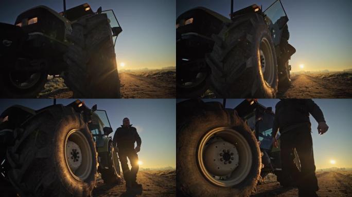 男性农民在日出时从阳光明媚的乡村田野中跳出拖拉机