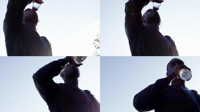 4k视频片段，一名年轻人因慢跑喝水而休息
