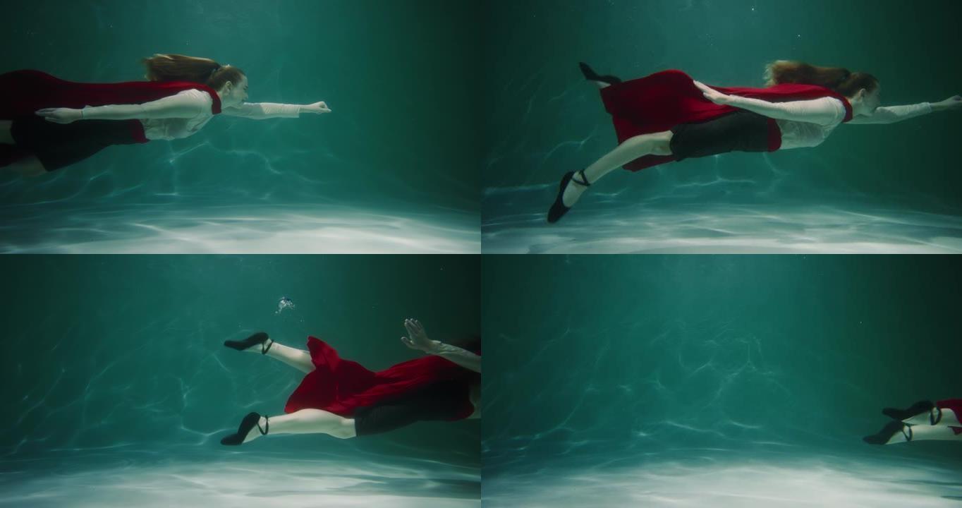 电影慢动作，美丽的超级英雄女商人与红色斗篷游泳水下伸手帮助慢动作。
