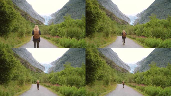 4k视频片段，一个无法识别的女人探索Briksdal冰川的山脉