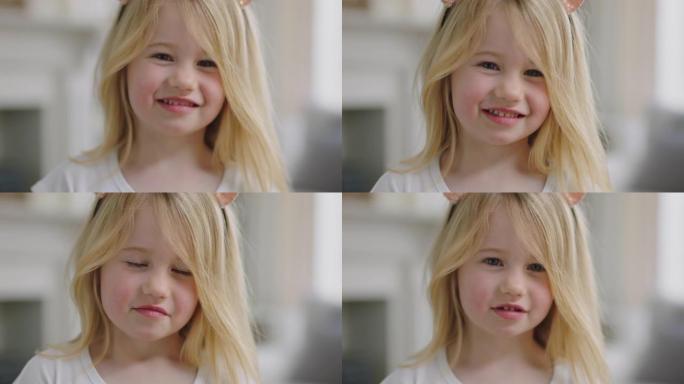 肖像美丽的金发小女孩微笑着看着相机快乐的孩子在家里