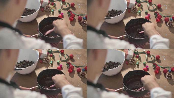 正上方亚洲中国甜点厨师烹饪准备和搅拌巧克力配料准备脆饼圣诞庆典